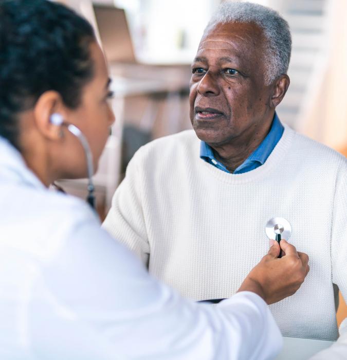 A provider checks her patient's heartbeat. 