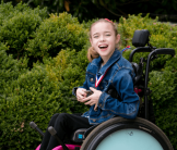 Madison Rogers, a young girl using a motorized wheelchair