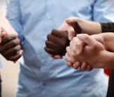 Group of people holding hands